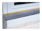 Window protected with masking tape and plastic sheeting for painting or renovation.