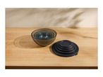 Set of nesting glass bowls with black lids on a wooden surface.