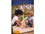 Two children playing in a wooden sandpit with sand toys under a blue canopy.