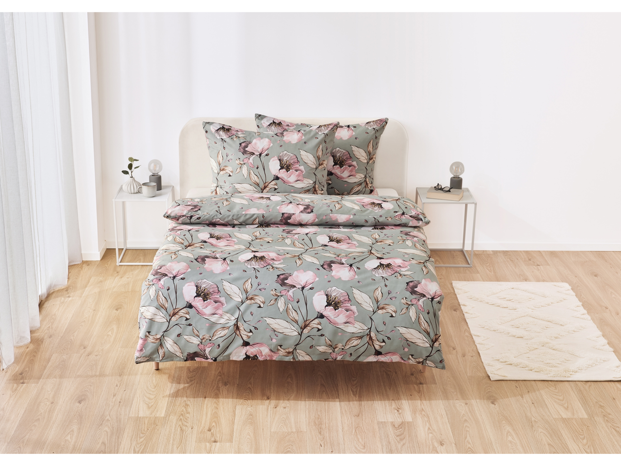 Floral duvet cover set on a bed in a light and airy bedroom.