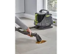 A person uses a Daewoo Hurricane Car 2 wet and dry vacuum cleaner to clean a spill on a tiled floor.
