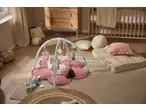 lupilu® Baby Activity Gym with a baby lying on a pink flower-shaped mat, surrounded by toys.