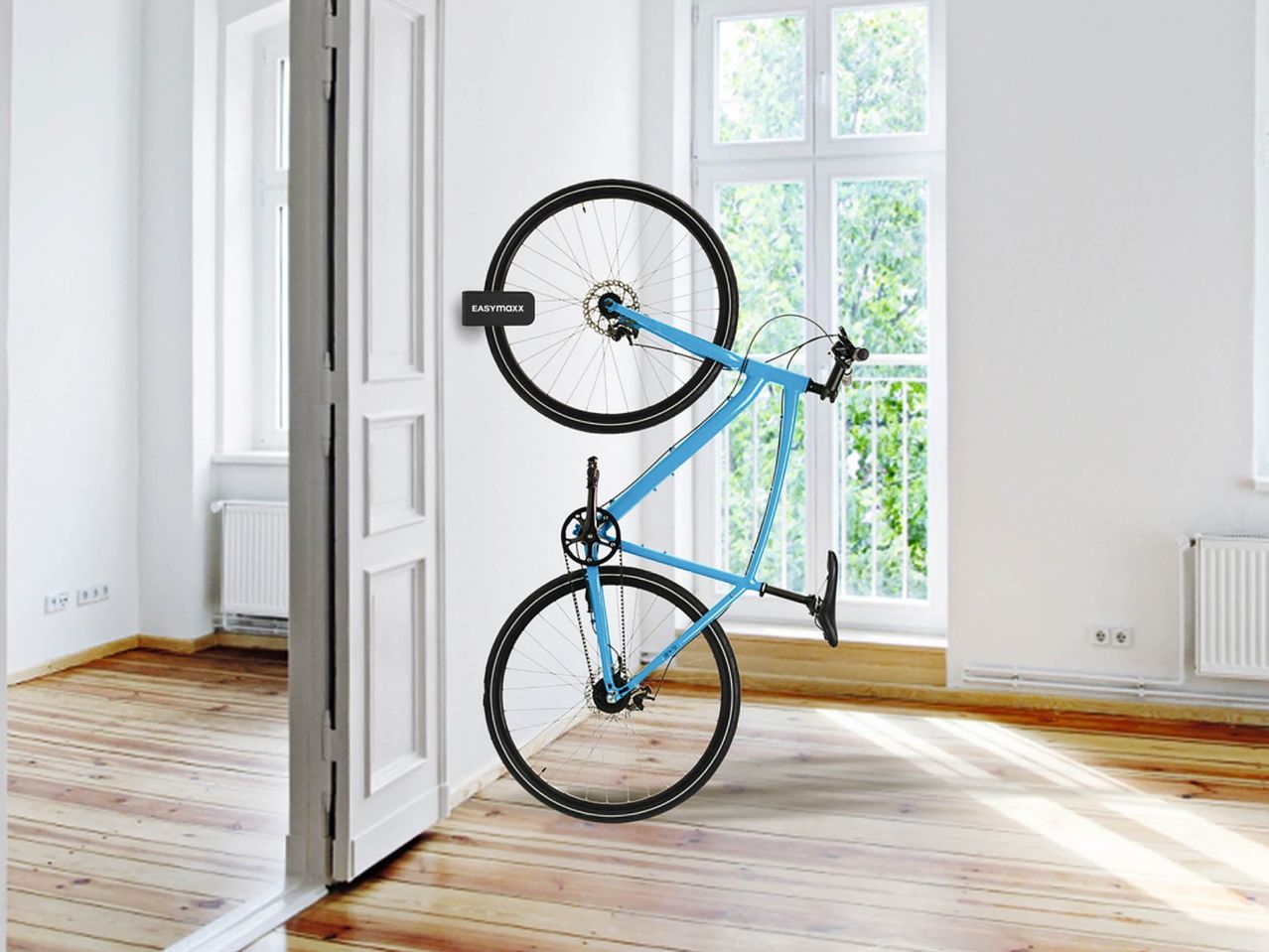 A blue bicycle mounted vertically on a white wall with an EASYmaxx Universal Bicycle Mounting Bracket.