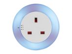 A white circular smart plug with a UK socket, glowing with blue and purple light.