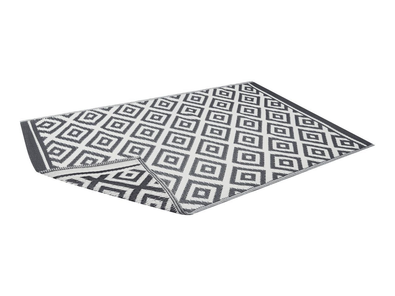 Grey and white geometric pattern outdoor rug, partially folded.