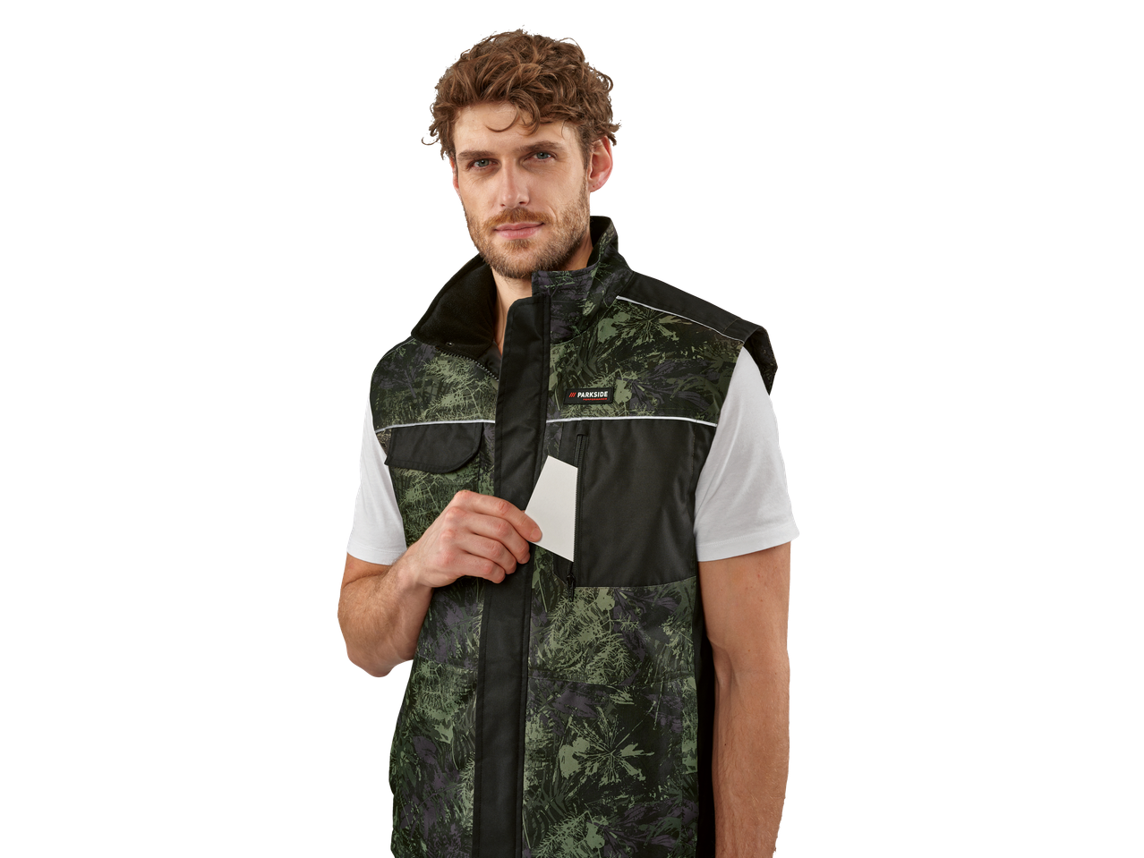 Man wears a Parkside camouflage work vest, holding a white card in his pocket.