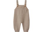 Knitted baby romper in a light brown color with shoulder straps and wooden buttons.