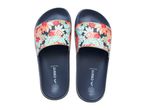 Pair of navy blue floral print slides with red, orange, and teal leaves.