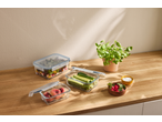 SILVERCREST® Glass Food Storage Containers with salad, cucumbers, and peaches on a wooden counter.