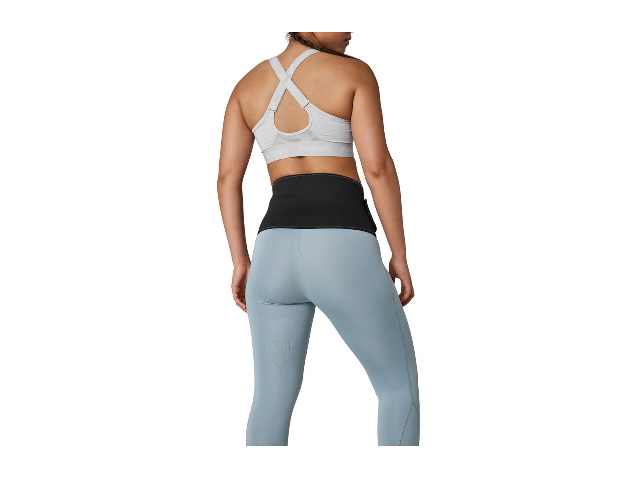 Woman from behind wearing a light grey sports bra, black waist trimmer, and light blue leggings.