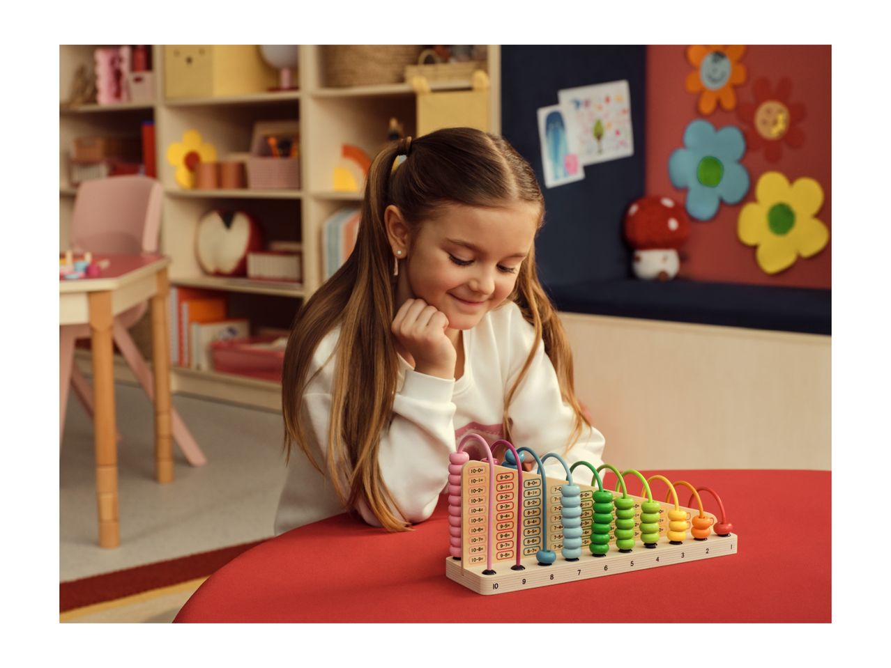 A girl playing with a colorful wooden abacus, learning numbers and basic math.