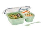 A light green bento box with salad, apple slices, and peanuts, with a matching spork.