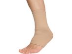 A person's foot and lower leg wearing a beige ankle support brace.