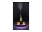 Gold-colored essential oil diffuser emitting purple light and mist against a dark background