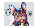Acrylic paint tubes in various colors, including green, white, black, yellow, red, and blue, arranged around a vibrant, impasto-style painting of a French Bulldog.