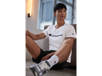 Man in Champion t-shirt and shorts.