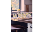 Gin and tonic cocktails with lemon and rosemary on a wooden counter in a kitchen.