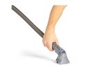 Hand holding a vacuum cleaner hose with an upholstery attachment