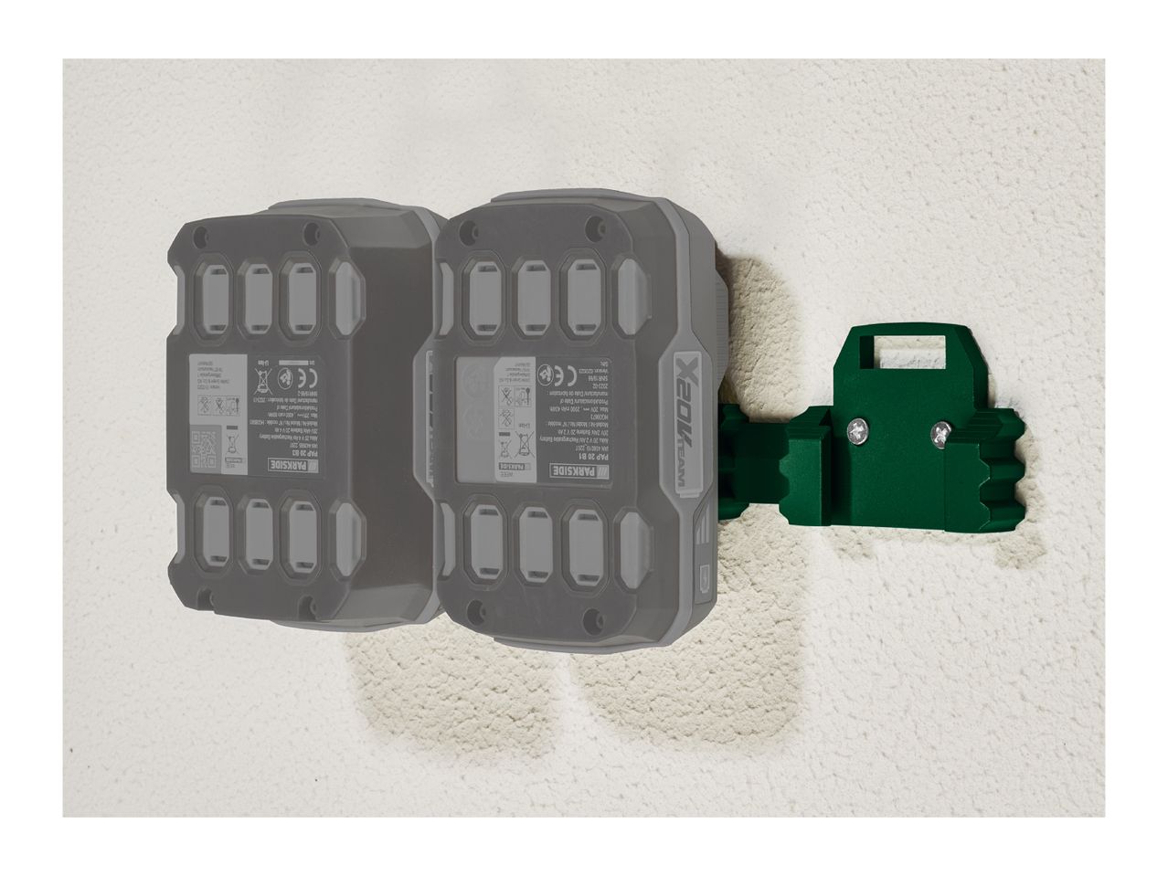 Two Parkside X20V Team batteries mounted on a green wall bracket.