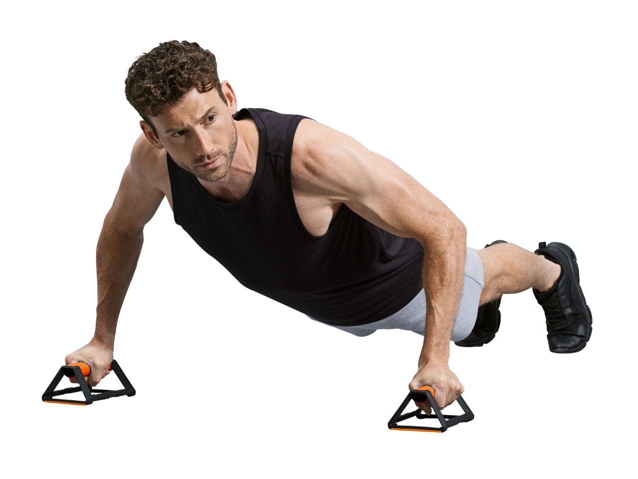 Man doing push-ups with push-up bars, wearing a black tank top and grey shorts.