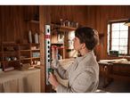 A woman uses a Parkside level and pencil to mark a wooden beam in a workshop.