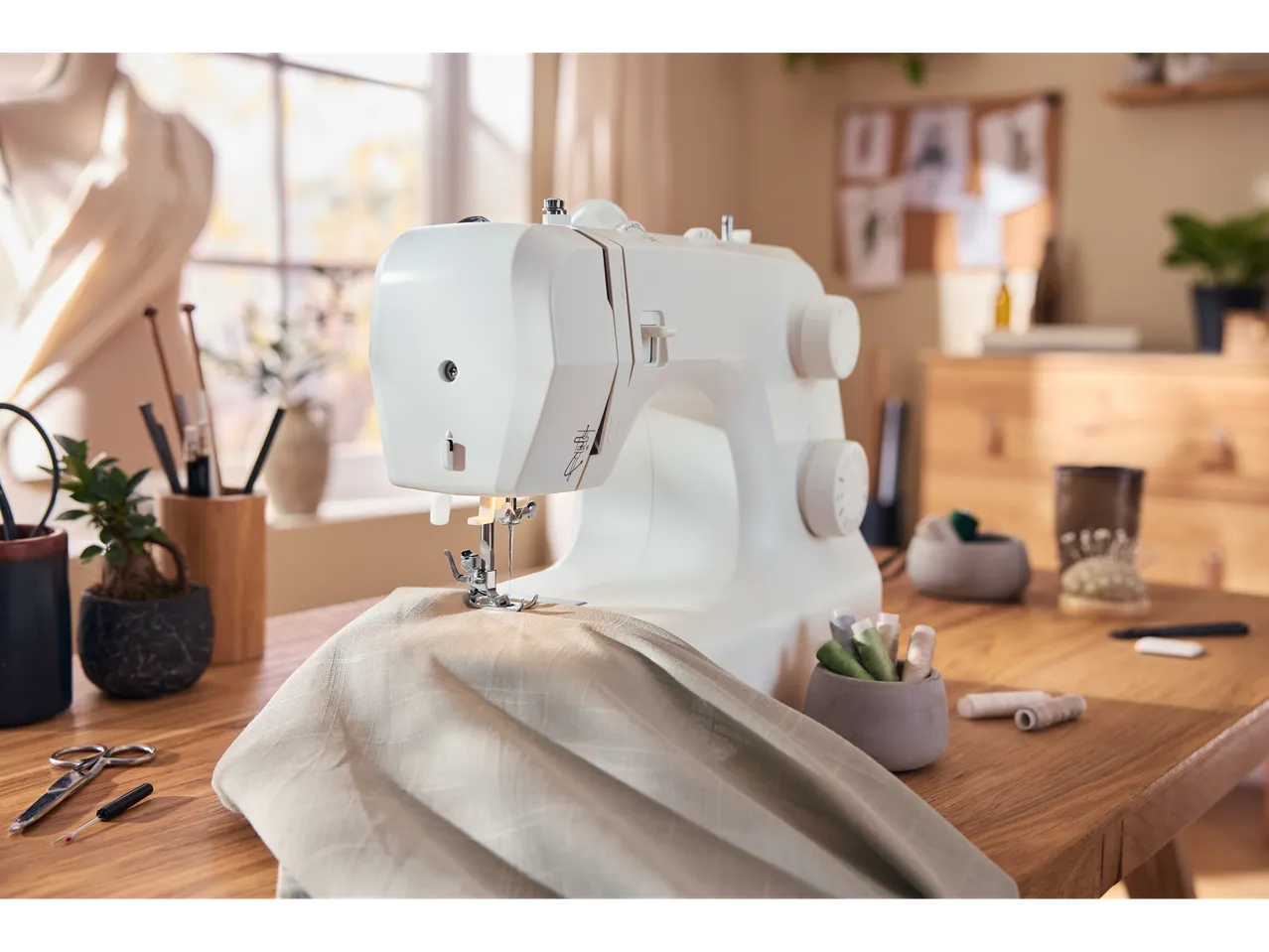 LIVARNO home Sewing Machine with fabric, scissors, and thread on a wooden table.