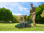 Man using a Parkside lawnmower.