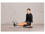Man exercising with a push-up board.