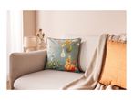 A cozy living room with a sofa, a decorative pillow, and a knitted throw blanket.