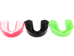 Three colorful mouthguards in pink, black, and green, for sports protection.