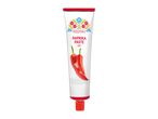 White tube of hot paprika paste with red chili peppers and folk art design.