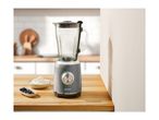 A SilverCrest blender on a wooden counter with blueberries and cream.