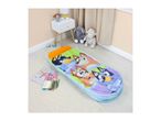 A children's sleeping bag with cartoon dog characters, next to a nightstand with toys.