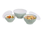 Three light green bowls with clear lids, filled with salad and gnocchi.
