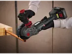 A worker uses a cordless angle grinder to cut copper pipe.