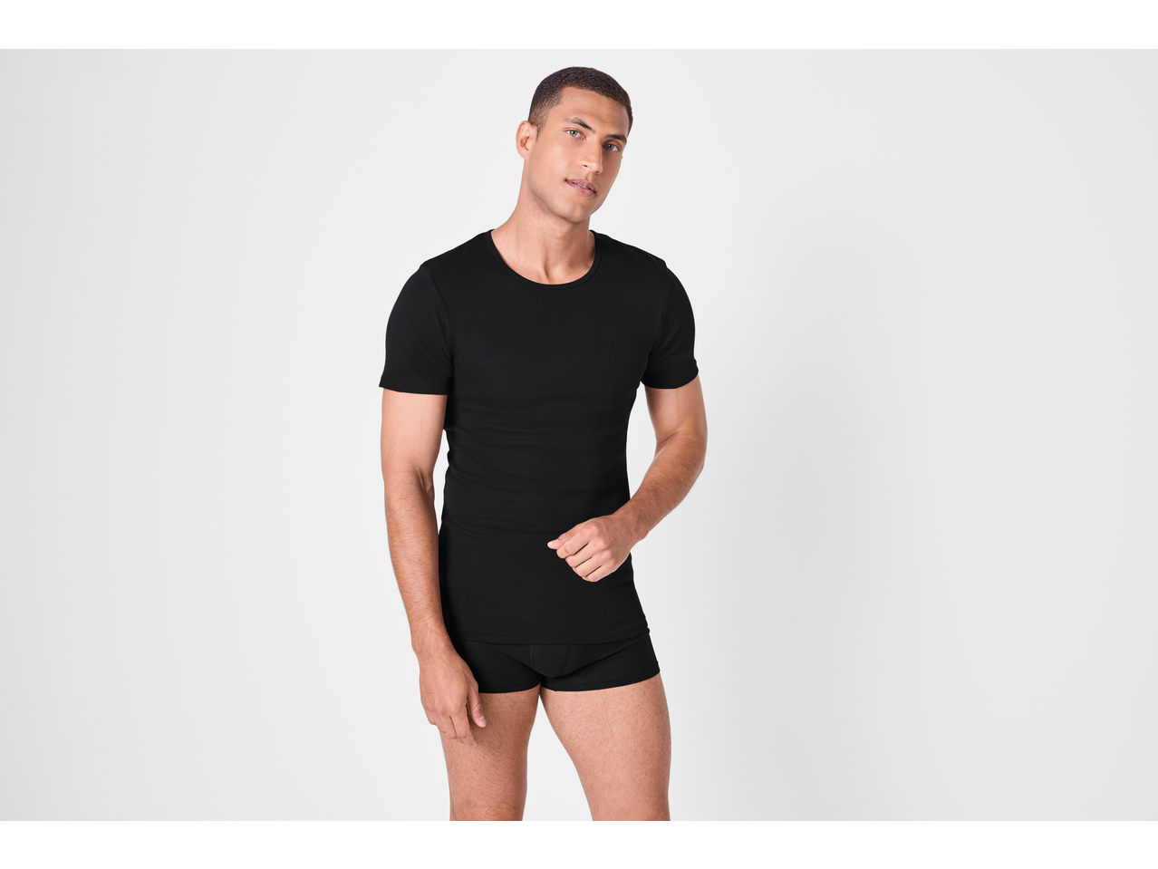 Man in a black crew neck t-shirt and black boxer briefs