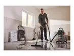Man using a Parkside wet and dry vacuum cleaner to clean a wet floor.