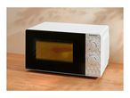 A white microwave oven with mechanical dials on a wooden table