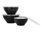 Stack of three black mixing bowls with white lids, one bowl open.