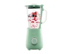 Mint green blender with berries and yogurt inside, ready for blending.