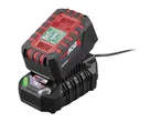 A red and black power tool battery charging on a black charger, with a green indicator light.