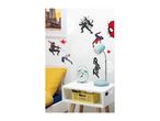 Spider-Man themed wall decals adorn a bedroom wall above a bedside table with a lamp and alarm clock.