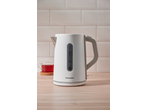 White electric kettle with a water level indicator, next to a cup of tea.