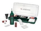 A repair kit with a green electric wax melter, various colored wax sticks, and accessories in a case.