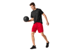Man in CRIVIT black t-shirt and red sports shorts holding a basketball.
