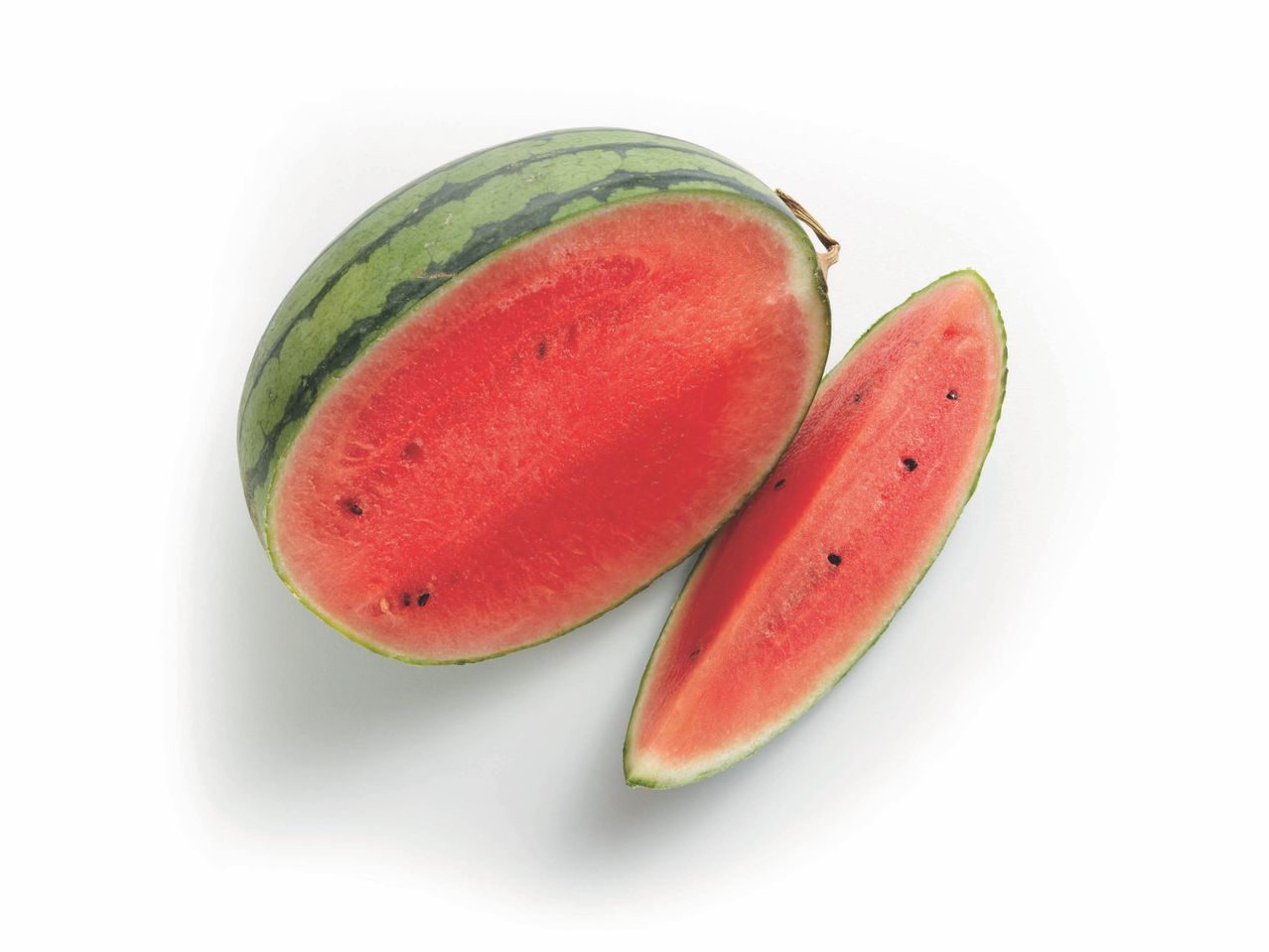 A halved watermelon with a slice beside it.