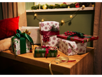 Crelando® wrapping paper in various festive designs with ribbons and decorations.