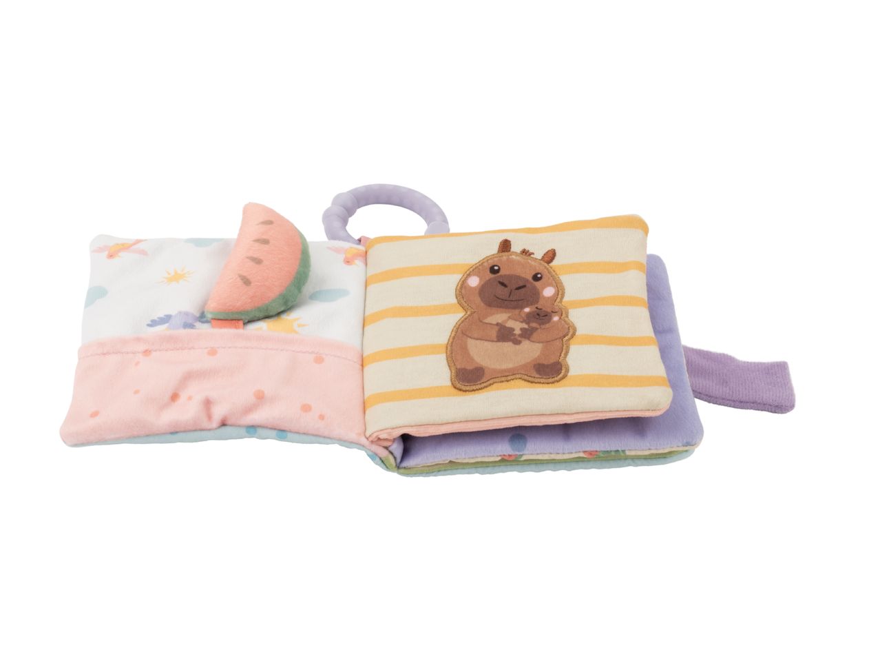 Open soft baby book with a watermelon, capybara, and colorful pages.