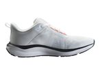White athletic shoe with black sole and orange accents, side view.
