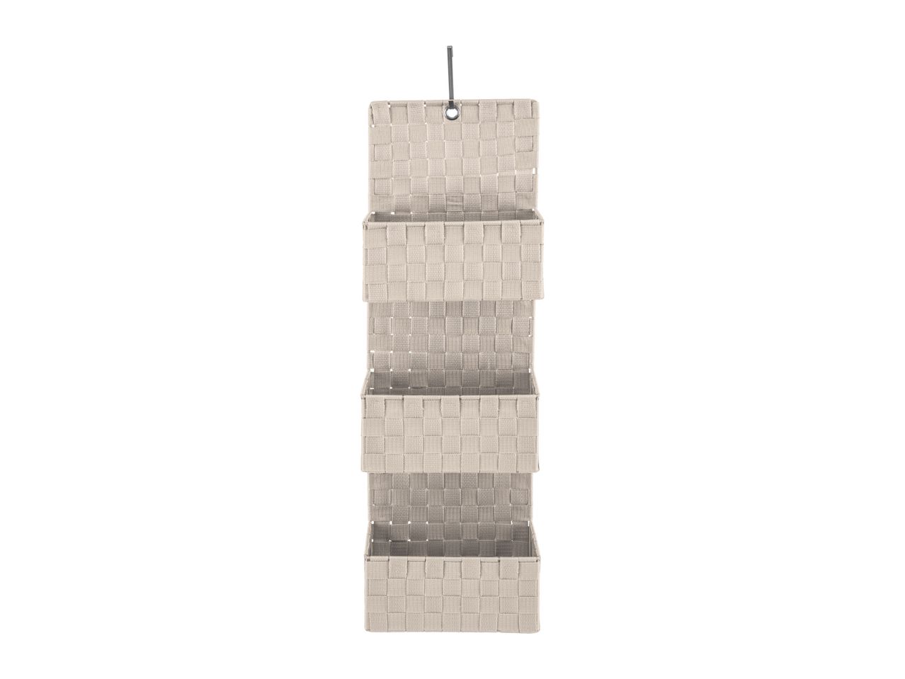 Beige fabric hanging organizer with three pockets.